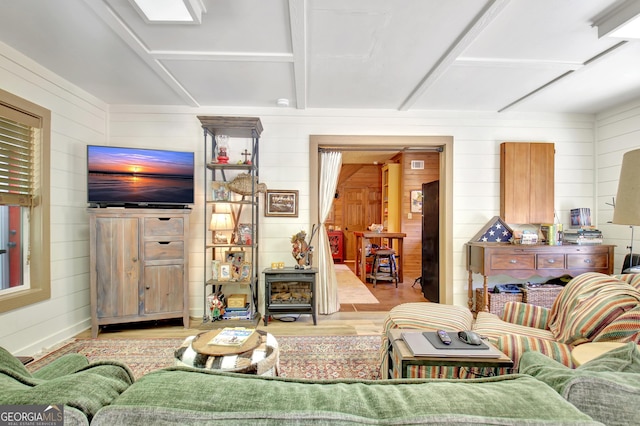 460 Morgan Mill Rd, Brooks, GA 30205 - living room featuring wooden walls, wood finished floors, and a wood stove