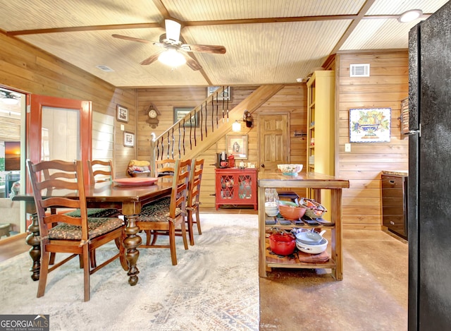 460 Morgan Mill Rd, Brooks, GA 30205 - dining room with wooden walls, ceiling fan, stairs, and concrete flooring