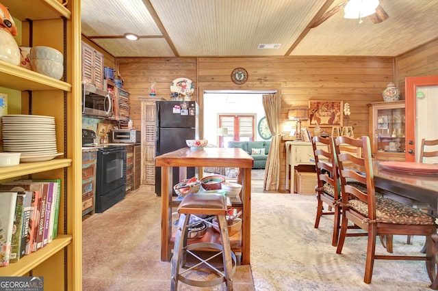 460 Morgan Mill Rd, Brooks, GA 30205 - dining area with wooden walls, light carpet, and ceiling fan
