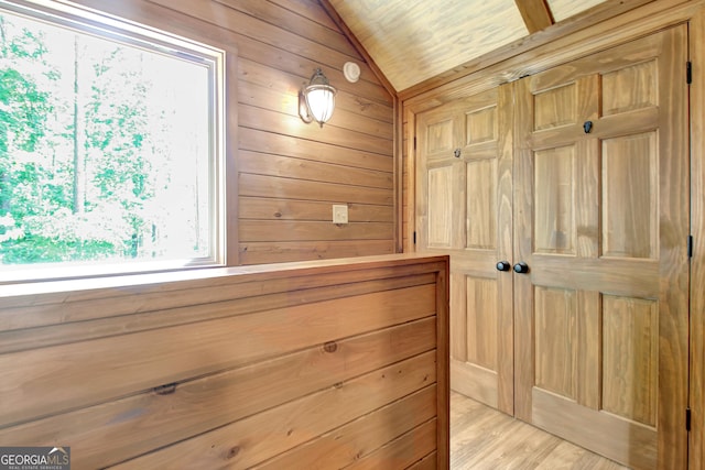 460 Morgan Mill Rd, Brooks, GA 30205 - hall featuring wood walls, lofted ceiling, and light wood-type flooring