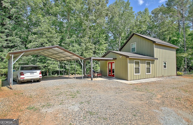 460 Morgan Mill Rd, Brooks, GA 30205 - view of property exterior with french doors, gravel driveway, a detached carport, and board and batten siding