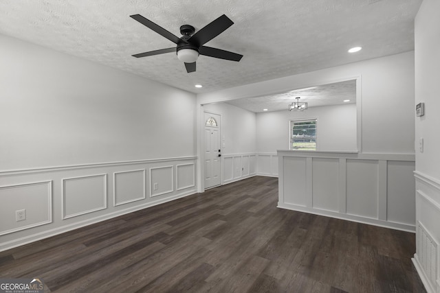 2800 Vultee Dr, Columbus, GA 31909 - empty room featuring a textured ceiling, dark wood finished floors, recessed lighting, a chandelier, and a decorative wall