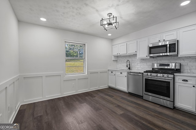 2800 Vultee Dr, Columbus, GA 31909 - kitchen featuring appliances with stainless steel finishes, light countertops, white cabinets, dark wood-style floors, and recessed lighting