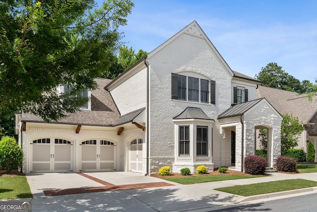 10580 Grandview Sq, Johns Creek, GA 30097 - french country inspired facade featuring concrete driveway, a standing seam roof, a shingled roof, and a metal roof