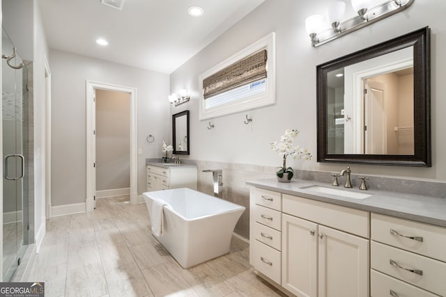 10580 Grandview Sq, Johns Creek, GA 30097 - full bath featuring a stall shower, two vanities, a freestanding tub, and recessed lighting