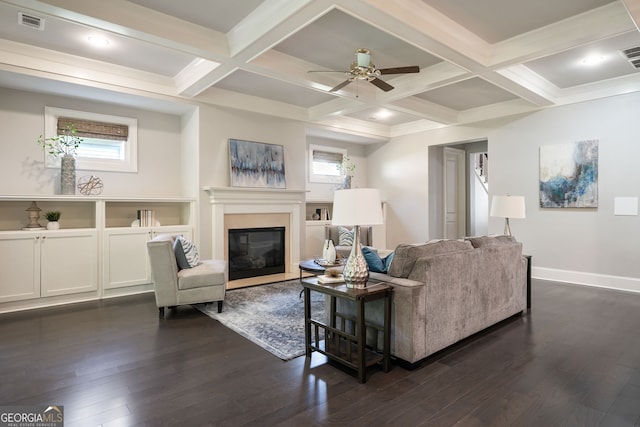10580 Grandview Sq, Johns Creek, GA 30097 - living room with dark wood finished floors, a glass covered fireplace, a ceiling fan, beamed ceiling, and coffered ceiling