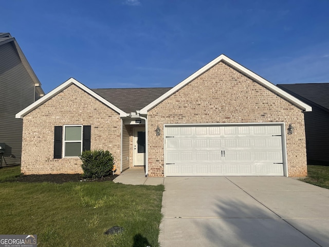 113 Sourwood Ln, Warner Robins, GA 31093 - ranch-style house with brick siding, concrete driveway, a garage, and a front yard