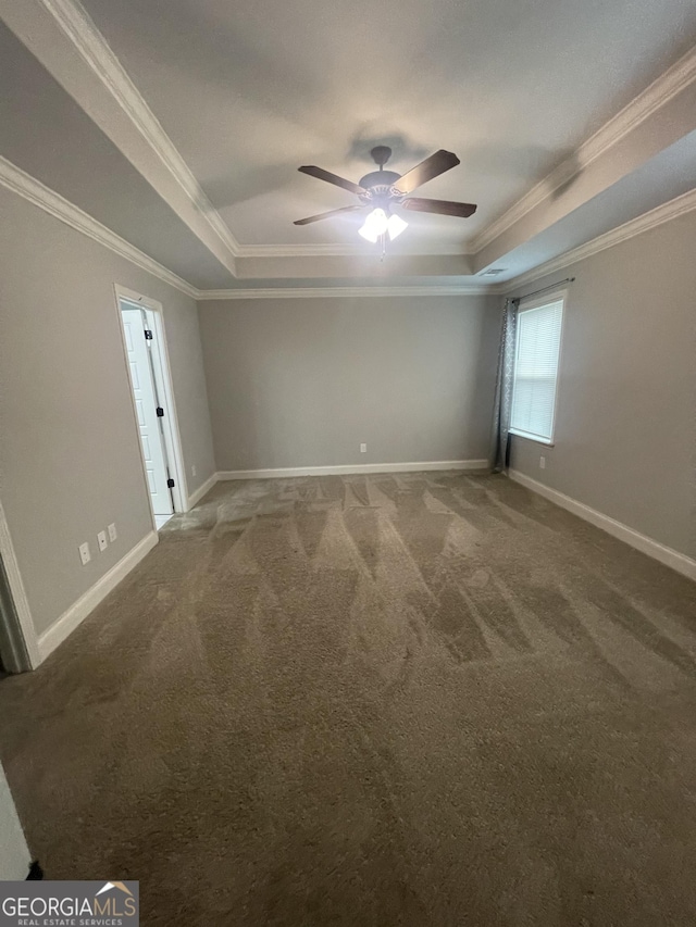 113 Sourwood Ln, Warner Robins, GA 31093 - empty room featuring a raised ceiling, carpet, ceiling fan, and crown molding