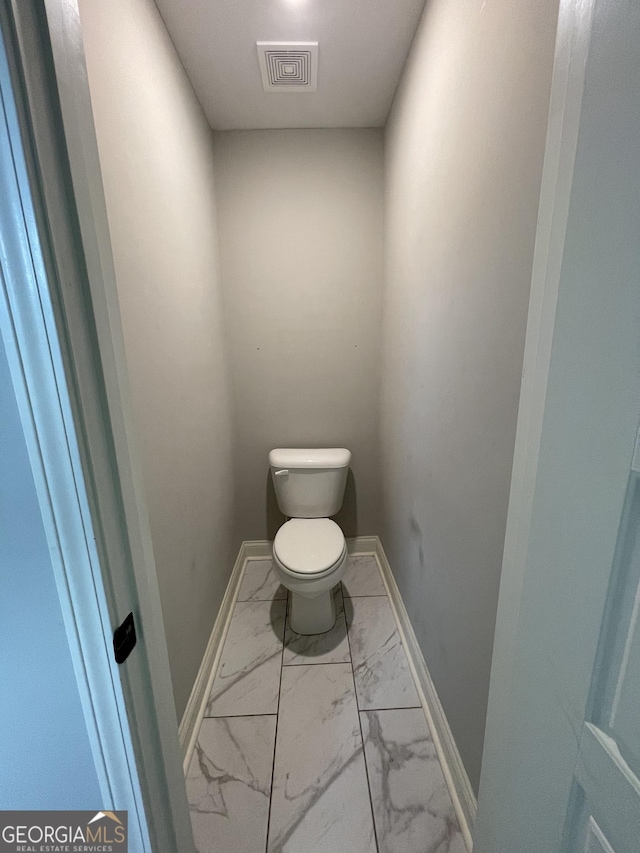 113 Sourwood Ln, Warner Robins, GA 31093 - bathroom with marble look tile flooring and toilet
