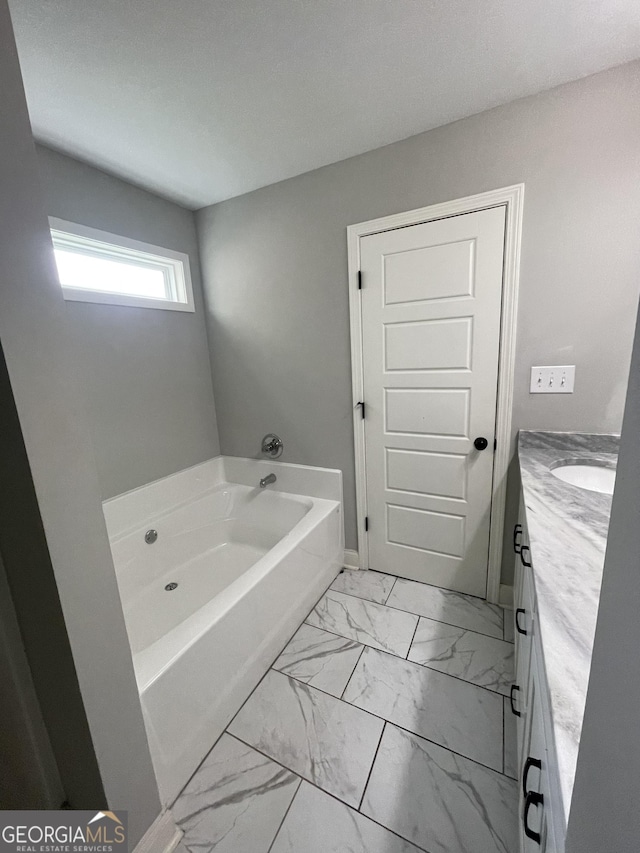 113 Sourwood Ln, Warner Robins, GA 31093 - bathroom with a garden tub, marble finish floors, and vanity