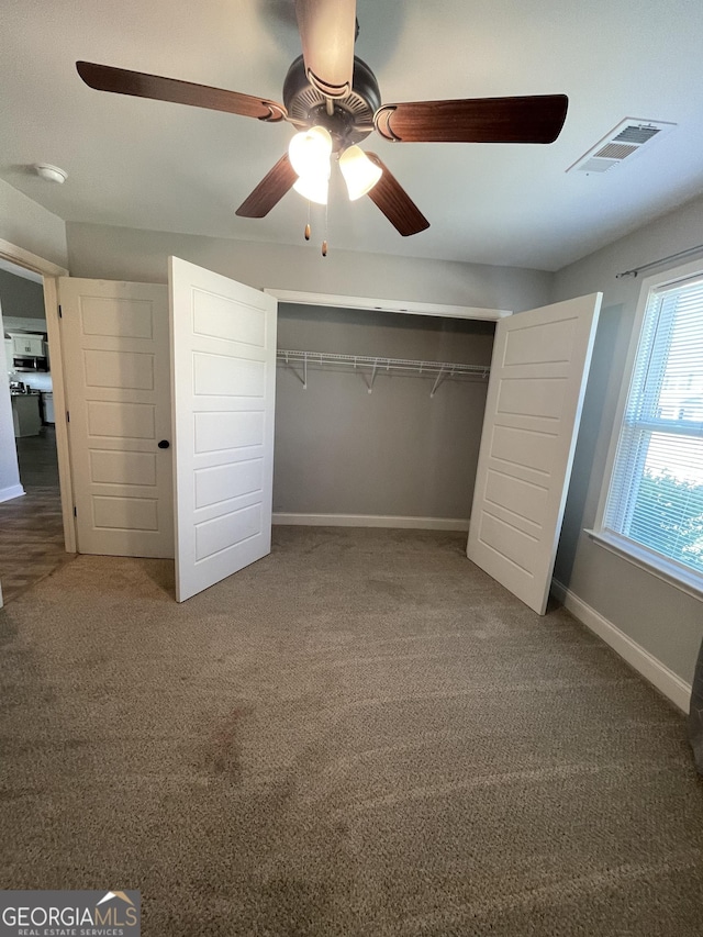 113 Sourwood Ln, Warner Robins, GA 31093 - unfurnished bedroom with carpet, a closet, and a ceiling fan