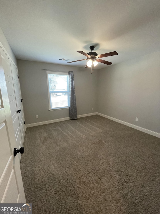 113 Sourwood Ln, Warner Robins, GA 31093 - spare room featuring ceiling fan and dark carpet