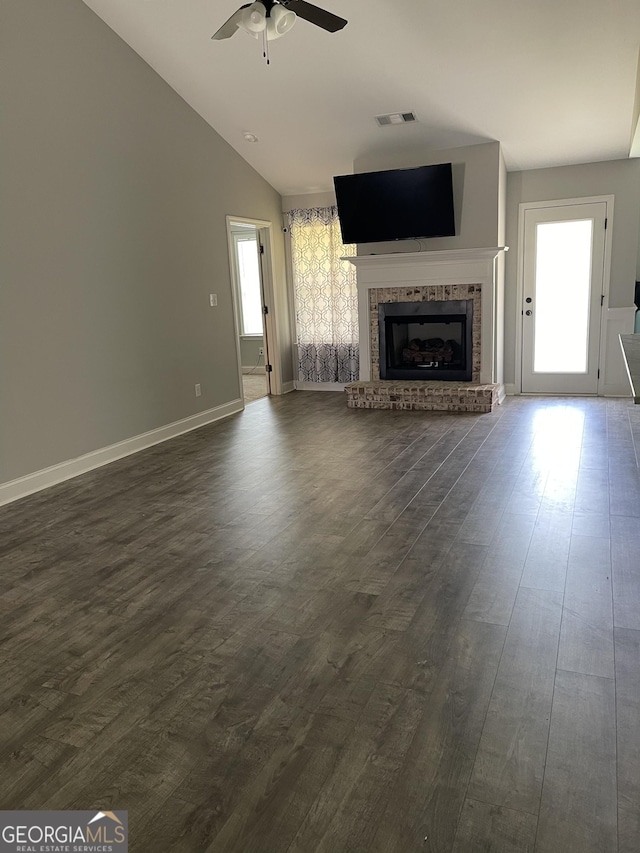 113 Sourwood Ln, Warner Robins, GA 31093 - unfurnished living room with ceiling fan, a brick fireplace, dark wood-style floors, and vaulted ceiling