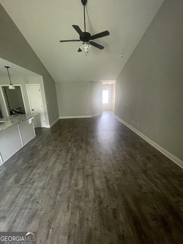 113 Sourwood Ln, Warner Robins, GA 31093 - unfurnished living room featuring vaulted ceiling, dark wood-type flooring, and a ceiling fan