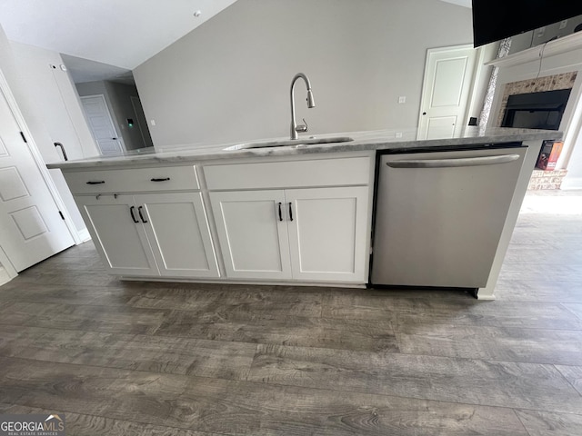 113 Sourwood Ln, Warner Robins, GA 31093 - kitchen with dishwasher, dark wood-type flooring, white cabinetry, vaulted ceiling, and light stone counters