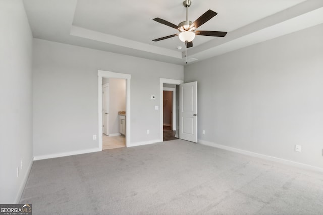 4601 Blacksmith Ln, Jefferson, GA 30549 - unfurnished bedroom with a raised ceiling, light colored carpet, connected bathroom, and ceiling fan