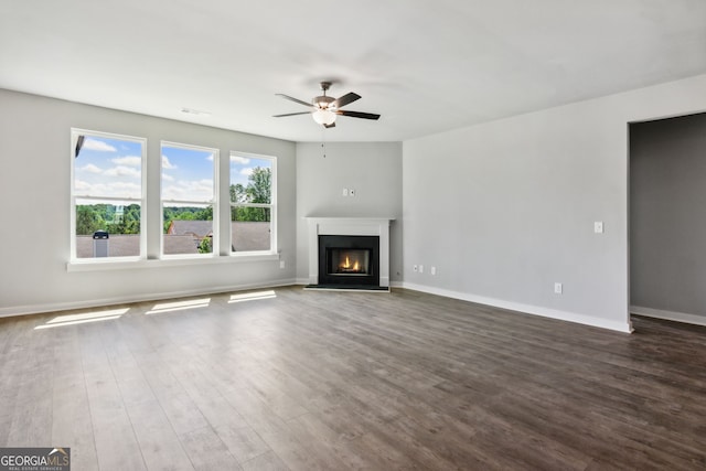 4601 Blacksmith Ln, Jefferson, GA 30549 - unfurnished living room with ceiling fan, dark wood-style floors, and a lit fireplace
