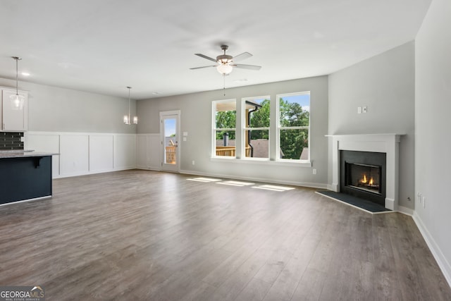 4601 Blacksmith Ln, Jefferson, GA 30549 - unfurnished living room with a lit fireplace, ceiling fan, and dark wood finished floors