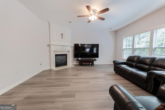 2940 Bentbill Xing, Cumming, GA 30041 - living room featuring a fireplace, a ceiling fan, and light wood finished floors