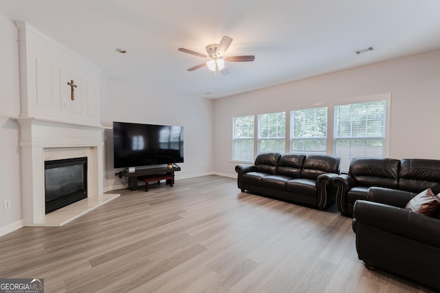 2940 Bentbill Xing, Cumming, GA 30041 - living area with a ceiling fan, light wood finished floors, and a premium fireplace