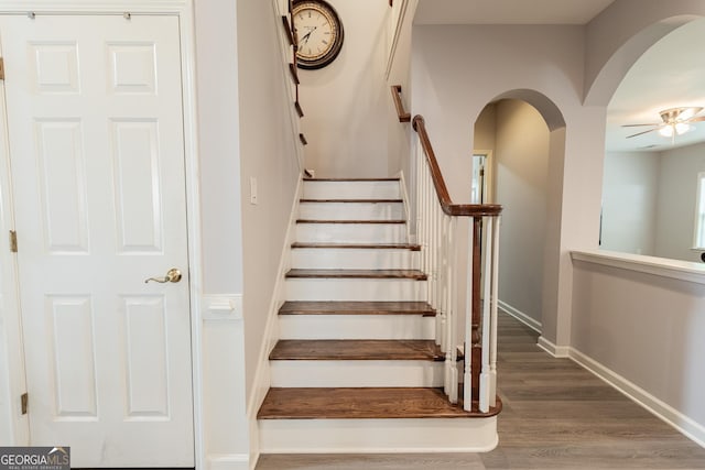 2940 Bentbill Xing, Cumming, GA 30041 - staircase featuring arched walkways, wood finished floors, and ceiling fan