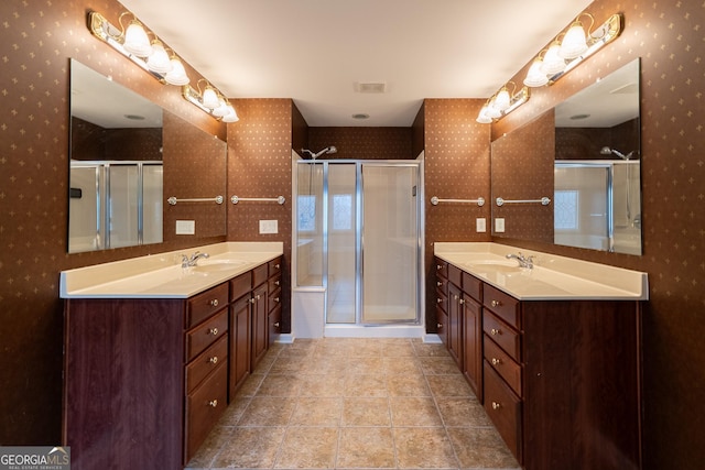 2940 Bentbill Xing, Cumming, GA 30041 - bathroom featuring wallpapered walls, two vanities, a stall shower, and tile patterned flooring