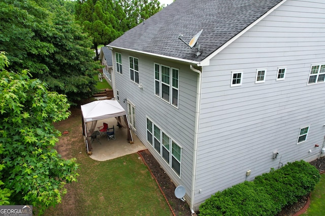 2940 Bentbill Xing, Cumming, GA 30041 - view of property exterior featuring a shingled roof, a patio area, and a yard