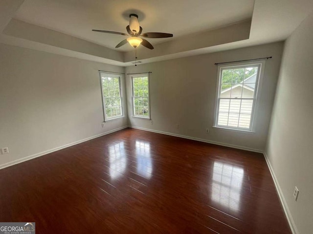 2994 Abbotts Oak Way, Duluth, GA 30097 - unfurnished room featuring a tray ceiling, dark wood-style flooring, and ceiling fan