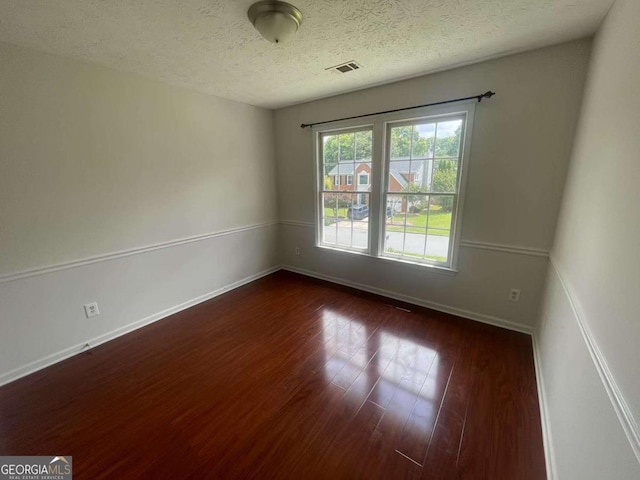 2994 Abbotts Oak Way, Duluth, GA 30097 - unfurnished room featuring dark wood-type flooring and a textured ceiling