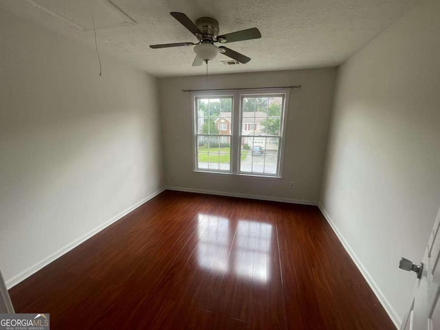2994 Abbotts Oak Way, Duluth, GA 30097 - spare room featuring attic access, dark wood-style flooring, a textured ceiling, and ceiling fan