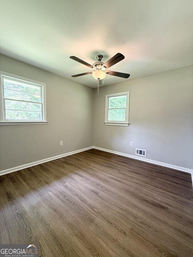882 Campbell Rd, Covington, GA 30014 - spare room with dark wood-style floors and a ceiling fan