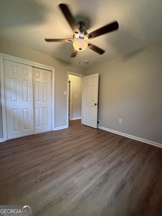 882 Campbell Rd, Covington, GA 30014 - unfurnished bedroom featuring dark wood-style flooring, a closet, and a ceiling fan