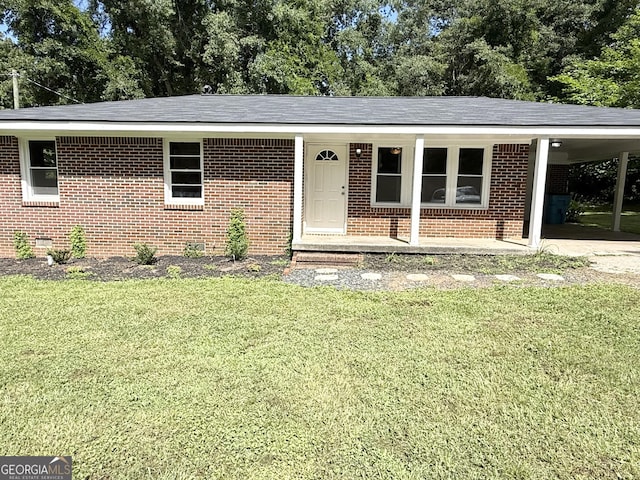 882 Campbell Rd, Covington, GA 30014 - single story home with brick siding, a front lawn, a carport, and view of wooded area