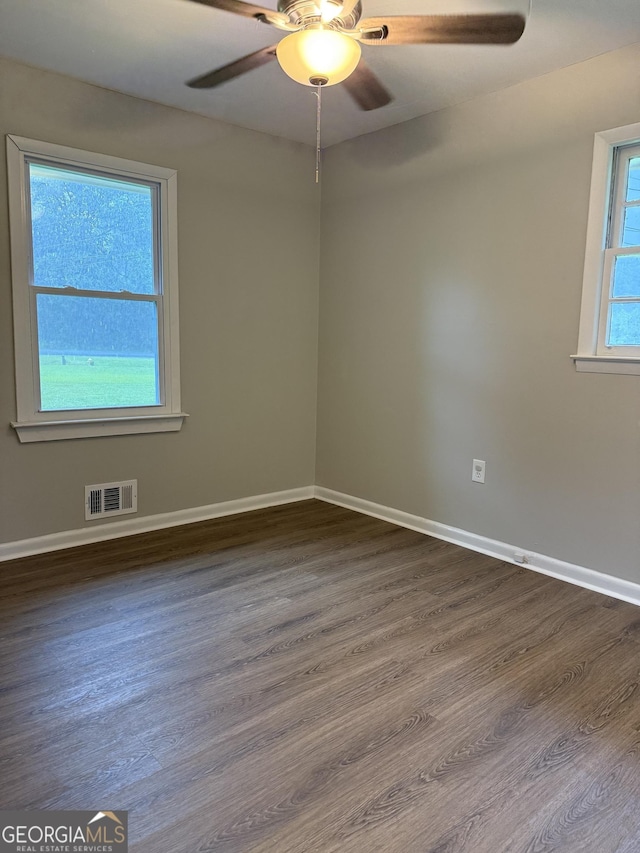 882 Campbell Rd, Covington, GA 30014 - spare room with a ceiling fan and dark wood-type flooring