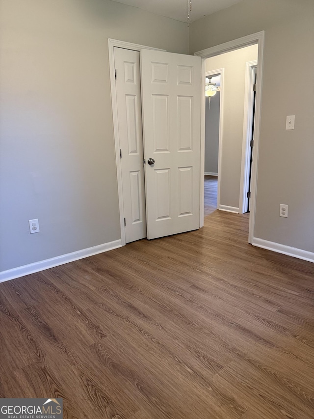 882 Campbell Rd, Covington, GA 30014 - unfurnished bedroom with dark wood finished floors