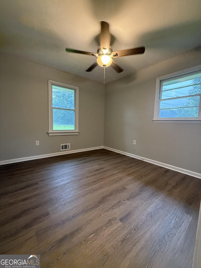 882 Campbell Rd, Covington, GA 30014 - unfurnished room with plenty of natural light, dark wood-style floors, and ceiling fan
