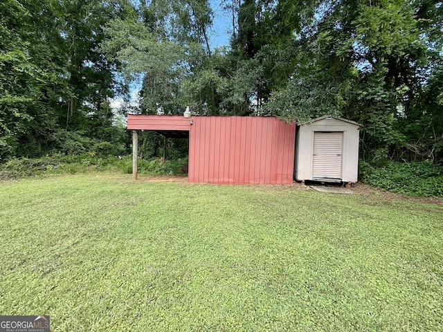 882 Campbell Rd, Covington, GA 30014 - view of green lawn with a storage shed and view of scattered trees