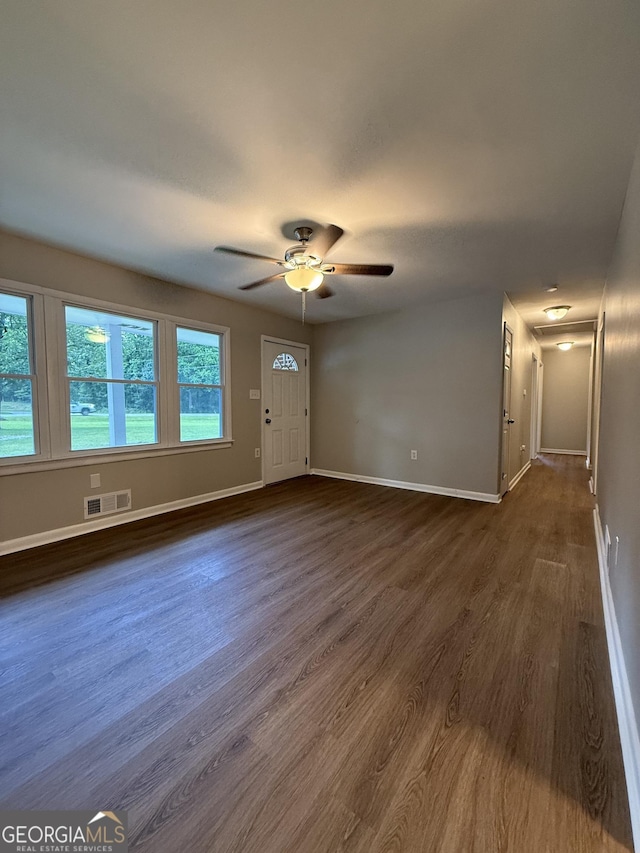 882 Campbell Rd, Covington, GA 30014 - unfurnished living room with dark wood-style flooring and ceiling fan