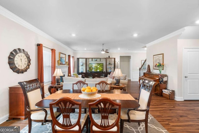 850 Ethereow Ct, Lawrenceville, GA 30046 - dining space with a ceiling fan, wood finished floors, recessed lighting, crown molding, and a fireplace