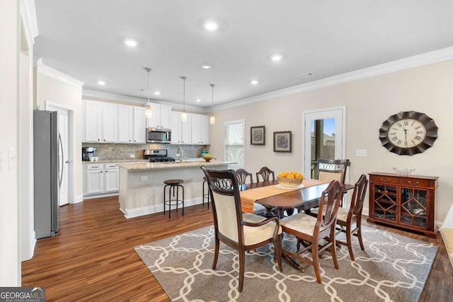 850 Ethereow Ct, Lawrenceville, GA 30046 - dining space featuring crown molding, dark wood finished floors, and recessed lighting