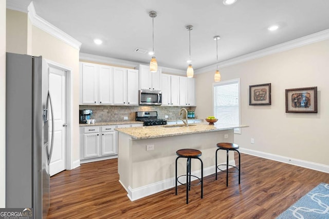 850 Ethereow Ct, Lawrenceville, GA 30046 - kitchen featuring appliances with stainless steel finishes, crown molding, dark wood-style flooring, white cabinetry, and tasteful backsplash