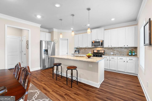 850 Ethereow Ct, Lawrenceville, GA 30046 - kitchen with stainless steel appliances, decorative backsplash, white cabinetry, dark wood-style floors, and a kitchen breakfast bar