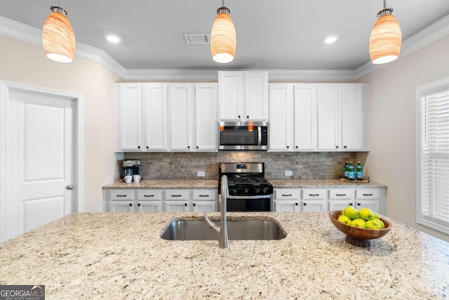 850 Ethereow Ct, Lawrenceville, GA 30046 - kitchen featuring stainless steel appliances, ornamental molding, white cabinetry, tasteful backsplash, and light stone countertops