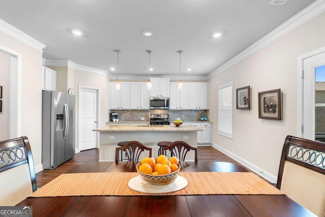 850 Ethereow Ct, Lawrenceville, GA 30046 - dining space with dark wood finished floors, ornamental molding, and recessed lighting