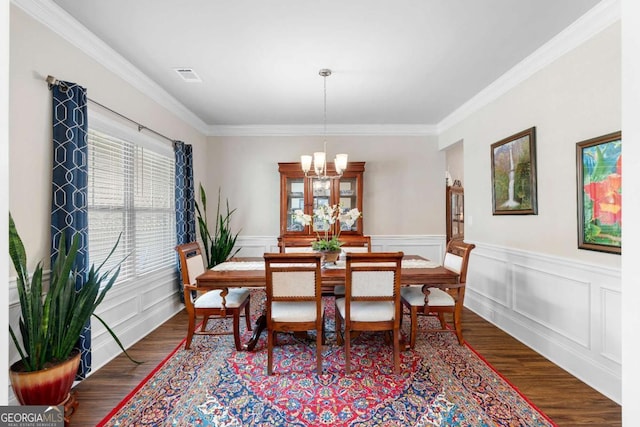 850 Ethereow Ct, Lawrenceville, GA 30046 - dining space with a chandelier, wood finished floors, crown molding, and wainscoting
