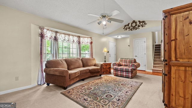3627 Spring Meadow Ct, Acworth, GA 30101 - living room featuring light carpet, vaulted ceiling, a ceiling fan, and stairway
