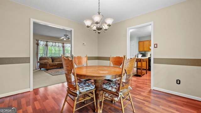 3627 Spring Meadow Ct, Acworth, GA 30101 - dining area with wood finished floors, a chandelier, and ceiling fan