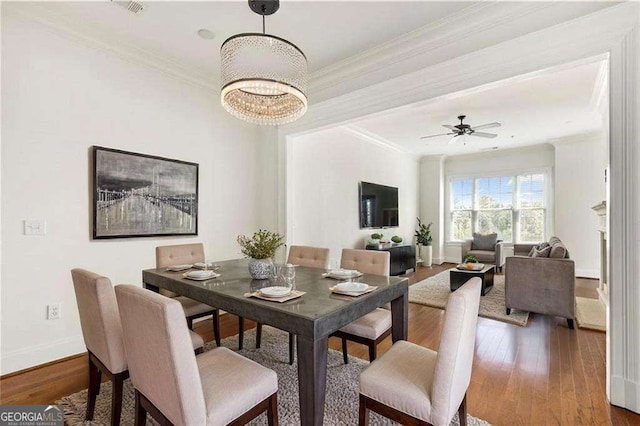 3635 E Paces Cir NE Unit 1405, Atlanta, GA 30326 - dining area featuring ornamental molding, wood finished floors, a chandelier, and ceiling fan
