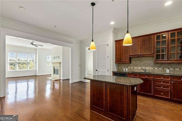 3635 E Paces Cir NE Unit 1405, Atlanta, GA 30326 - kitchen featuring a ceiling fan, tasteful backsplash, a kitchen island, pendant lighting, and glass insert cabinets
