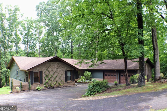1310 Larkview Dr SW, Lilburn, GA 30047 - single story home with driveway, brick siding, and a garage